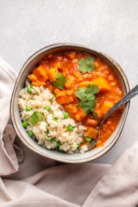 sweet potato stew in bowl with rice and peas