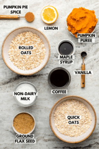 Ingredients for pumpkin spice latte overnight oats in small bowls on stone background. Clockwise text labels read pumpkin puree, maple syrup, vanilla, coffee, quick oats, ground flax seed, non-dairy milk, rolled oats, pumpkin pie spice, and lemon