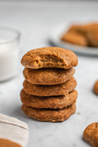 stack of cashew butter snickerdoodles with bite taken out of top one on marble background