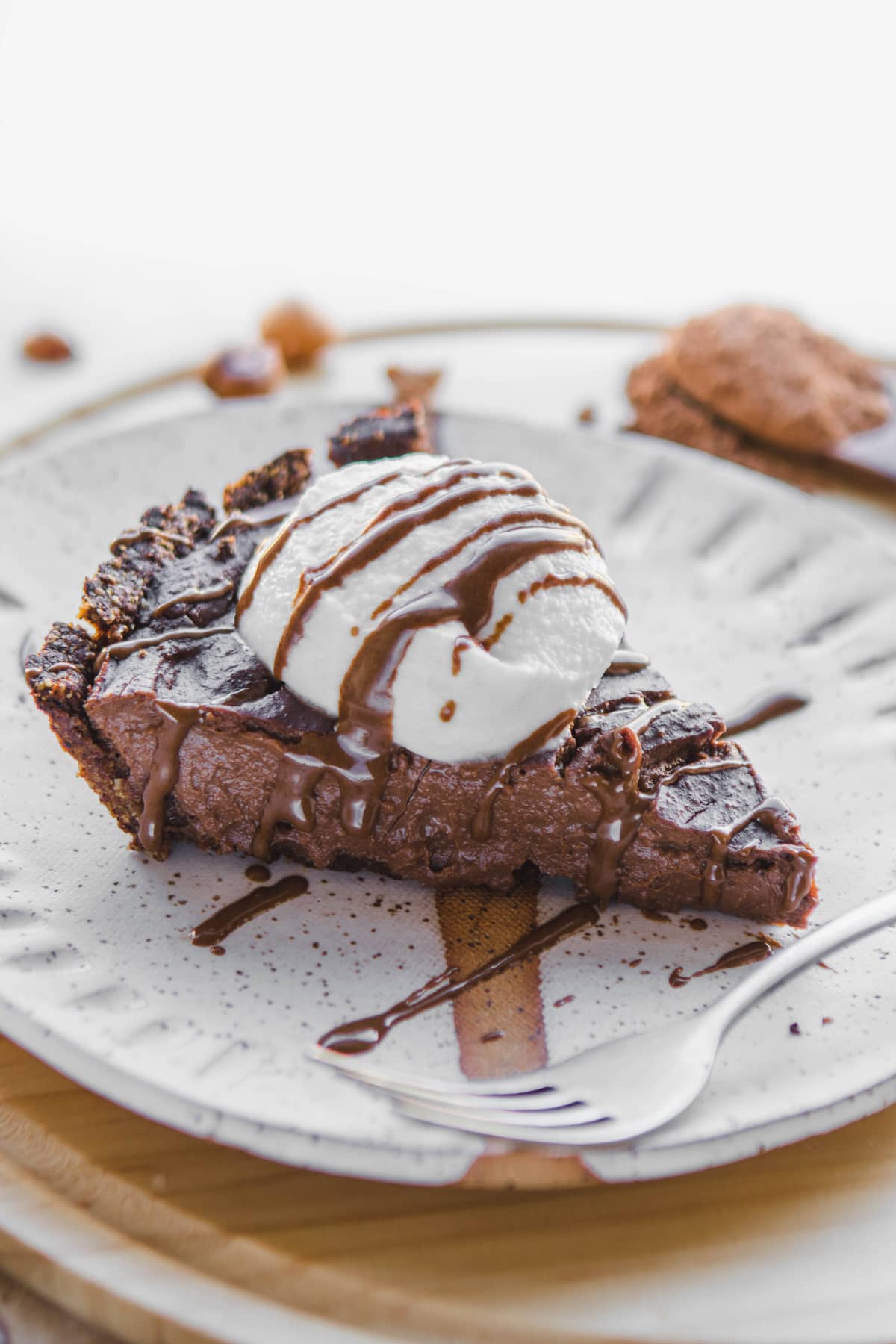 Chocolate Hazelnut Pudding Pie on white plate with whipped cream