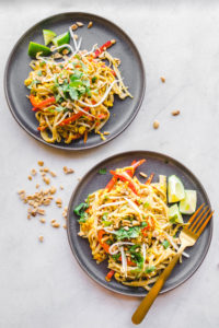 vegan pad thai with tofu and bean sprouts on grey plate