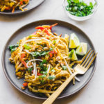 vegan pad thai with tofu and bean sprouts on grey plate
