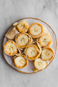 peanut butter banana sushi on white plate