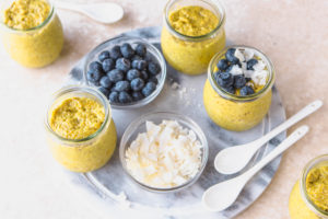 golden milk chia pudding jars with blueberries and coconut