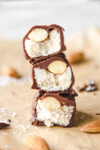 stack of sliced almond joy bars on parchment paper