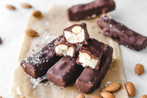 stack of almond joy bars on parchment paper