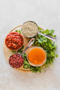 ingredients for rice and beans on wood cutting board