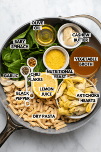 ingredients for spinach artichoke pasta arranged in pan