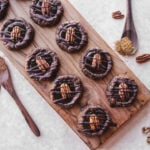 Chocolate Turtle Cookies on wood cutting board