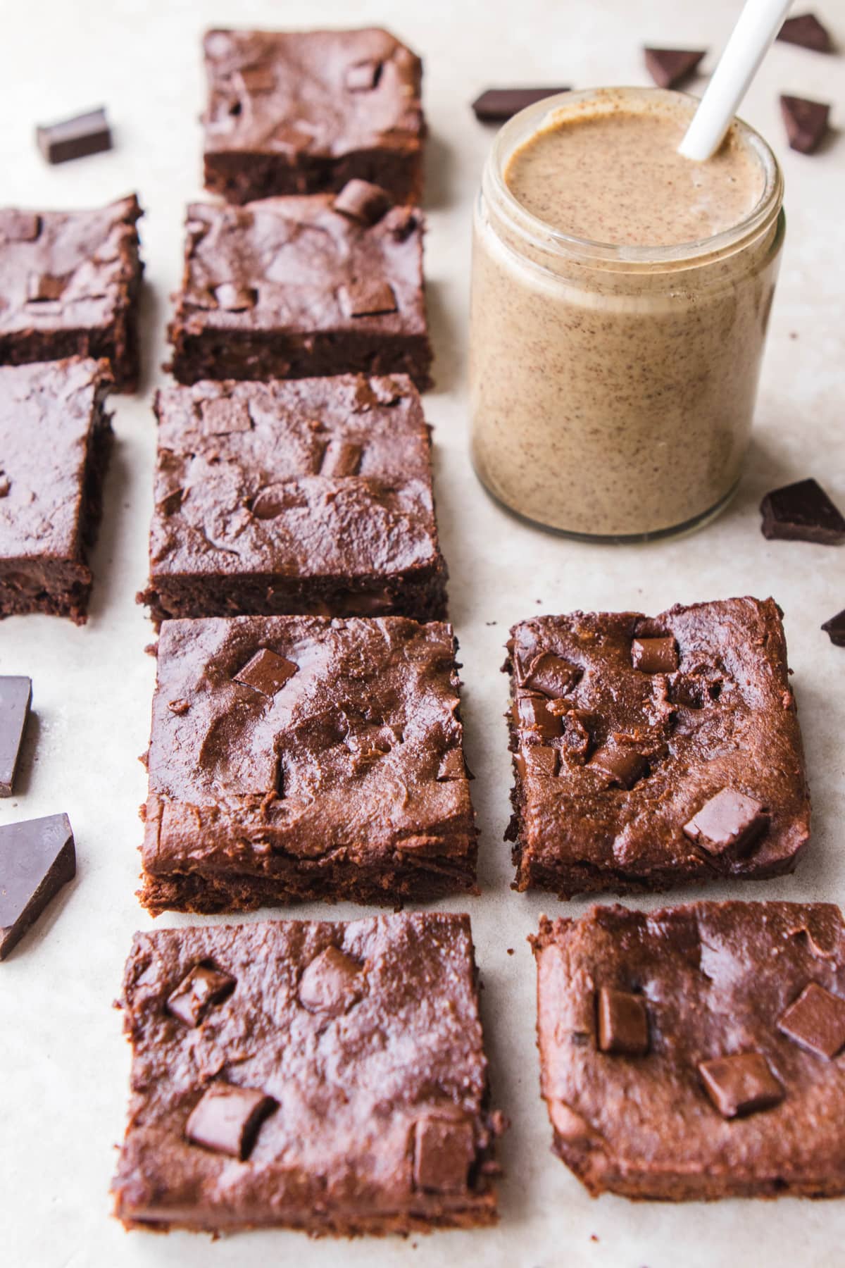 brownie squares with jar of almond butter