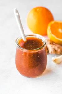orange sauce in glass jar with oranges