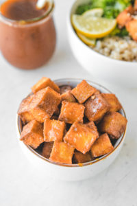 crispy orange tofu in white bowl
