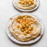 plates of hummus with chickpeas