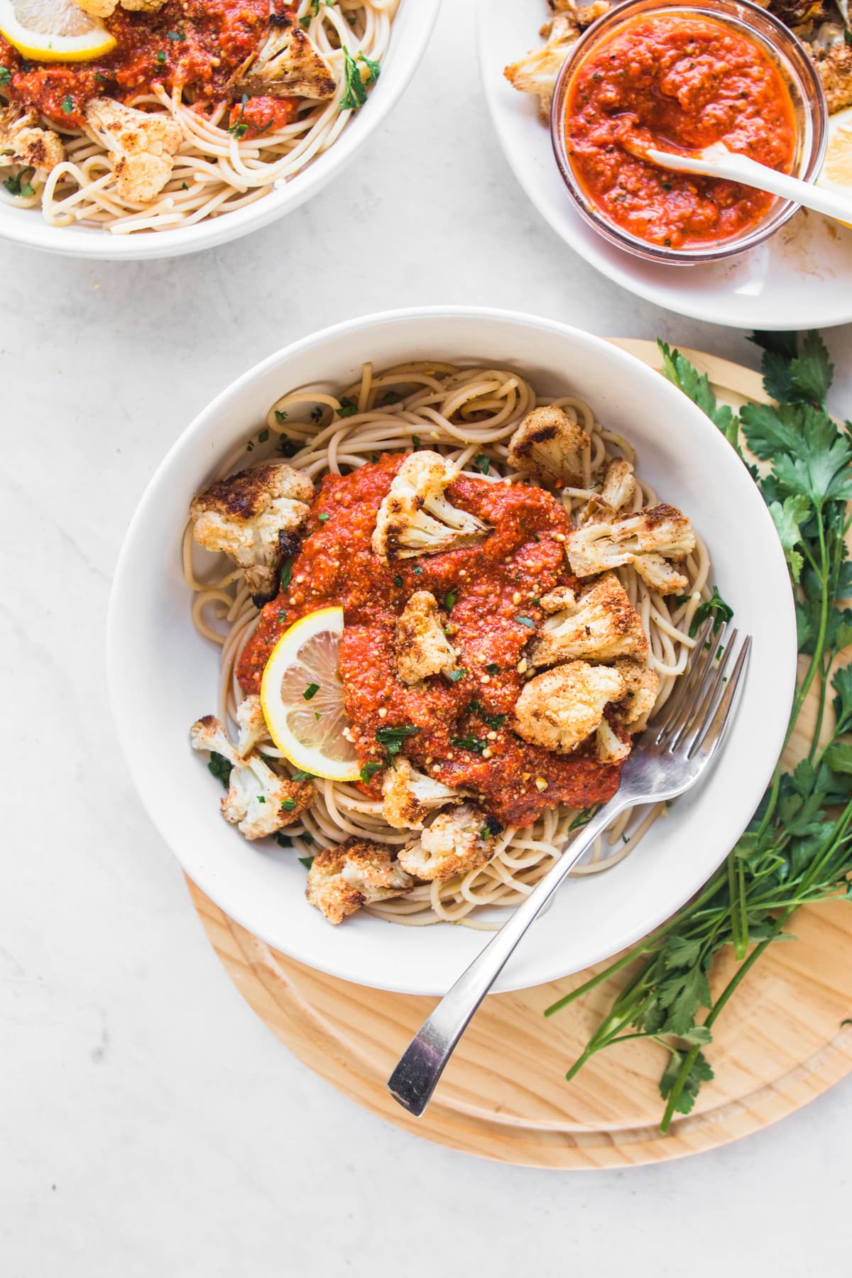 pasta bowls with romesco sauce and roasted cauliflower on the side