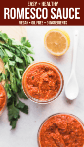 romesco sauce in jars with parsley and lemon