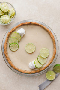 key lime pie with limes and whipped cream
