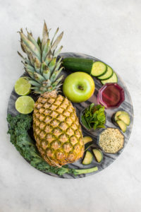 ingredients for pineapple mint smoothie on gray marble cutting board