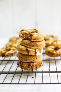 stack of toasted coconut baked donuts on cooling rack