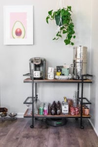 bar cart with mugs, coffee, and alcohol