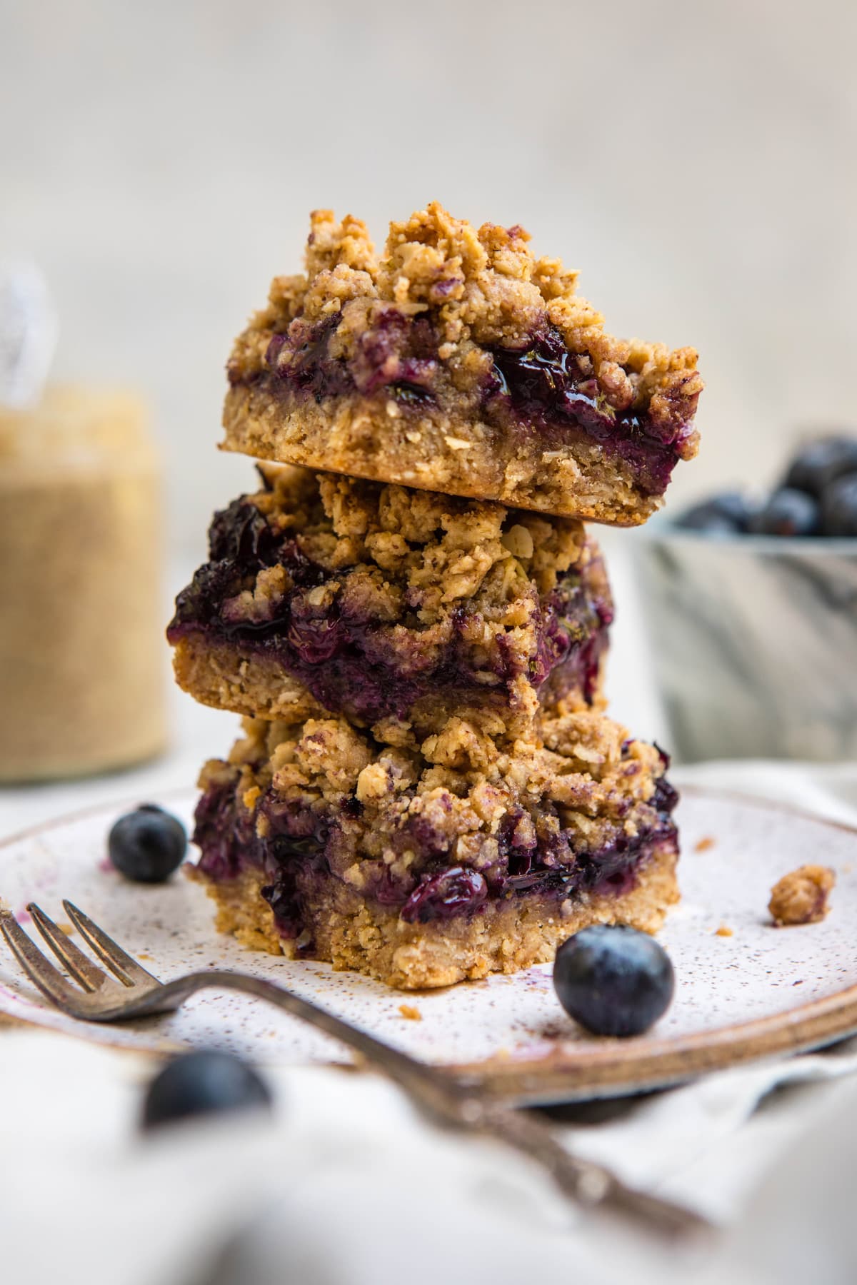 stack of blueberry crumble bars on white plate