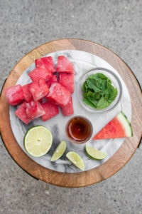 ingredients for watermelon slushie on marble cutting board