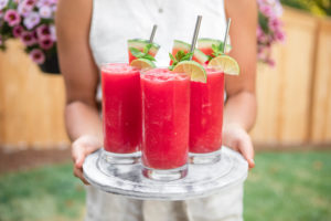 3 glasses of watermelon slushie on marble serving tray