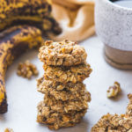 stack of banana oatmeal breakfast cookies with cup of coffee