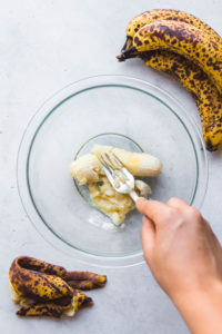 mashing ripe banana in a bowl