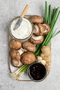 ingredients for creamy mushroom dumplings on white serving tray