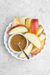 apples with healthy caramel sauce in white bowl