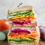 rainbow veggie sandwiches cut in half and wrapped in parchment paper