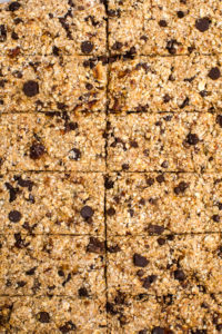 close up photo of vanilla chip buckwheat bars scored on baking sheet