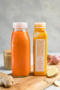 comparison of homemade carrot ginger dressing and trader joes dressing bottles