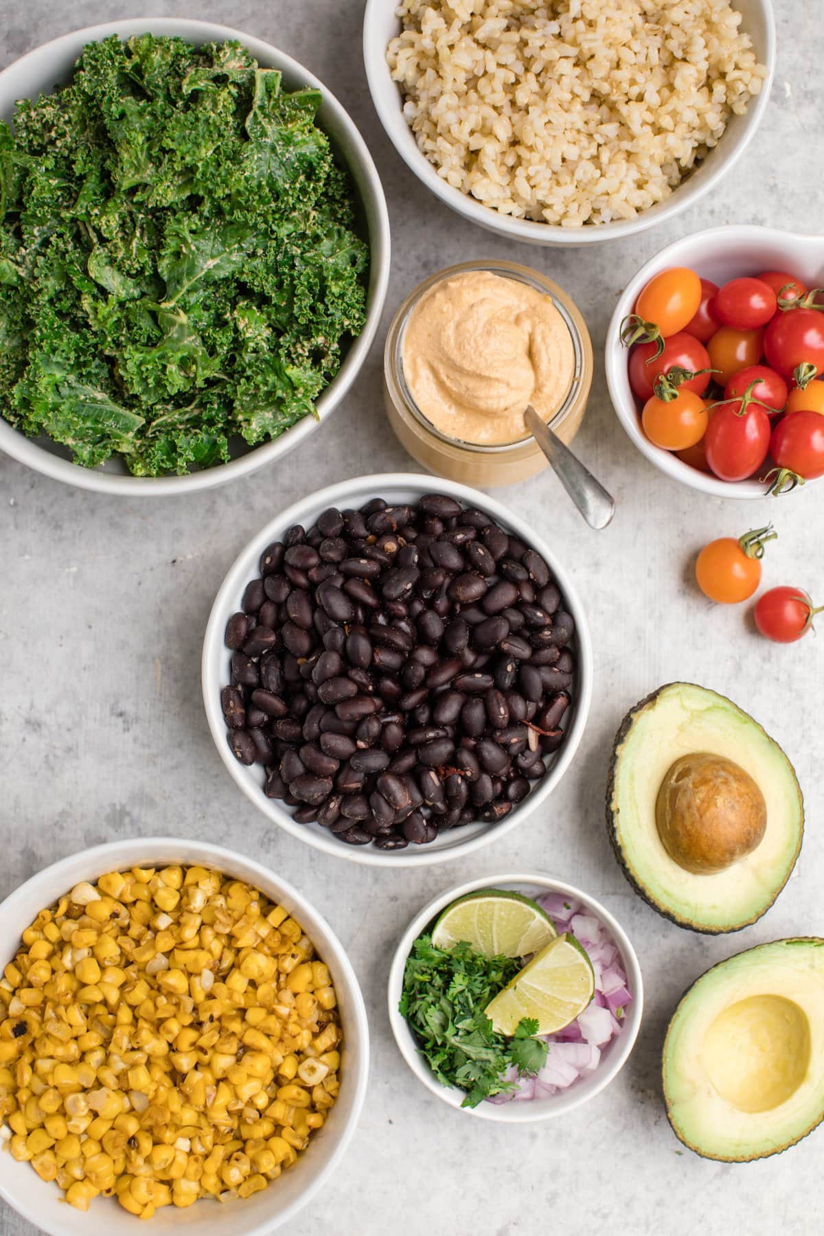 ingredients for black bean burrito bowls in white bowls 
