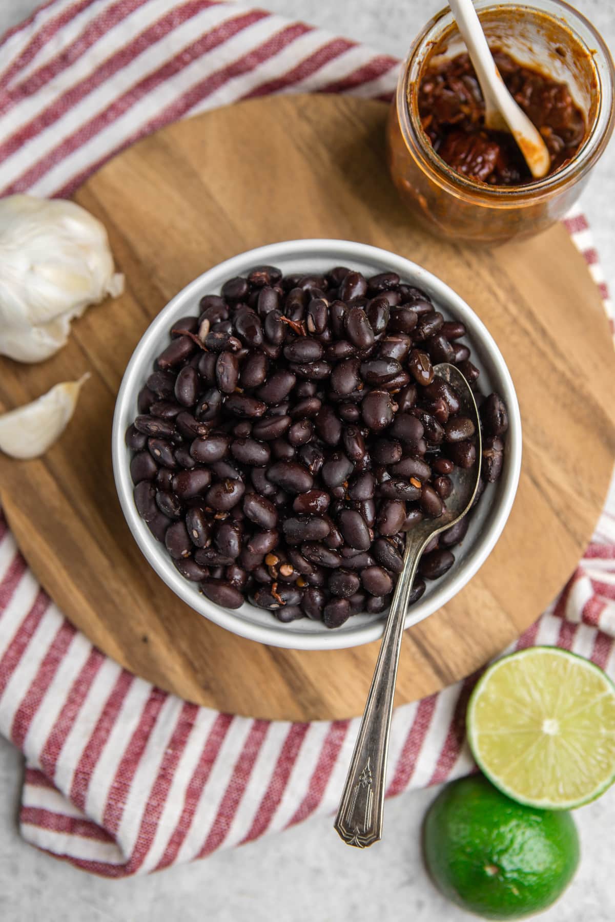 white bowl of instant pot chipotle black beans on wood background