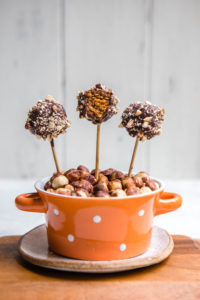 chocolate covered pumpkin spice cake pops in orange spotted bowl