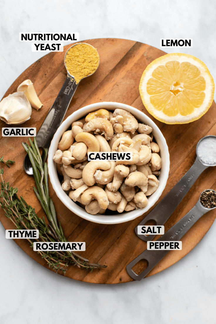 ingredients for rosemary garlic cashew cream on wood cutting board
