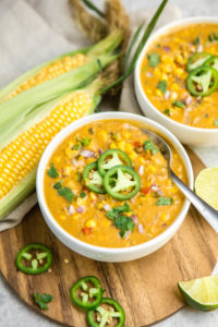 bowl of corn chowder on wooden background