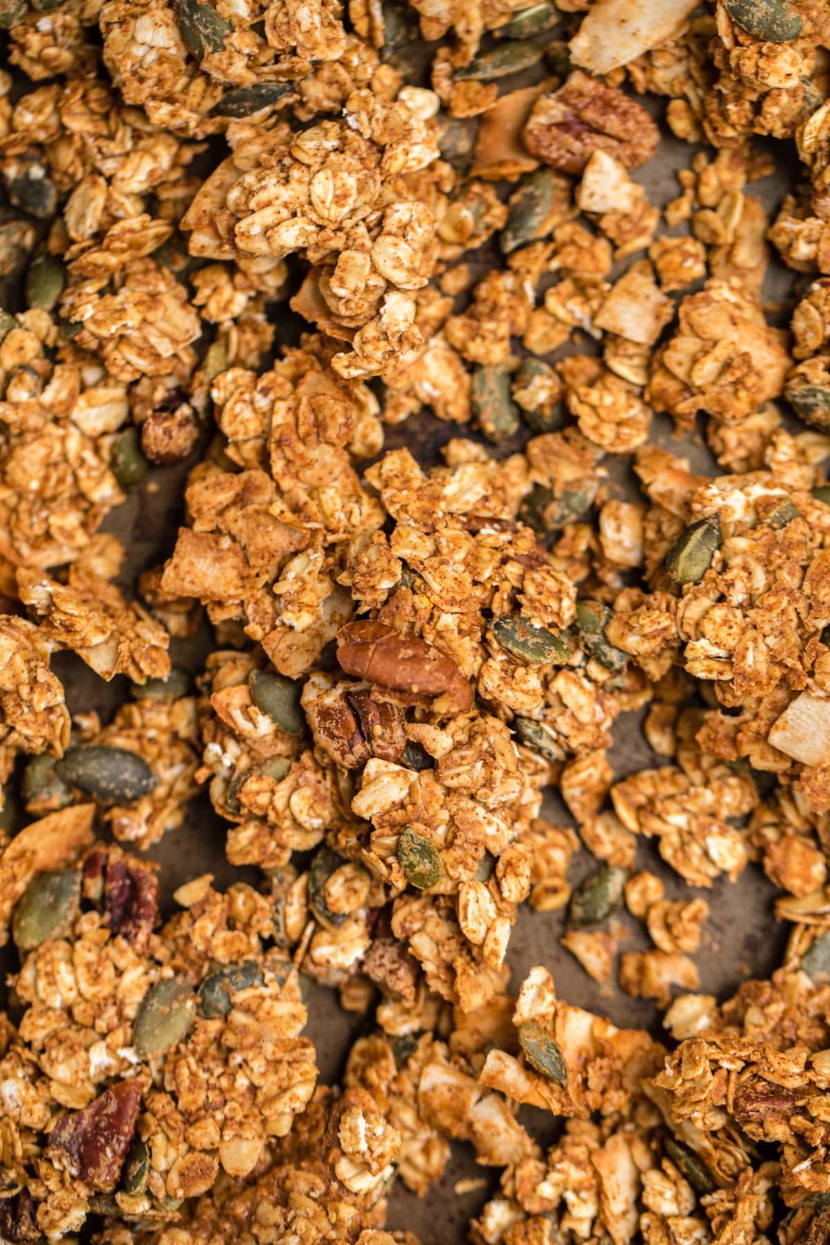 close up photo of pumpkin spice granola on baking tray