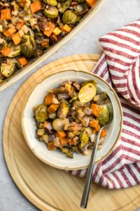 white serving dish filled with roasted vegetable casserole