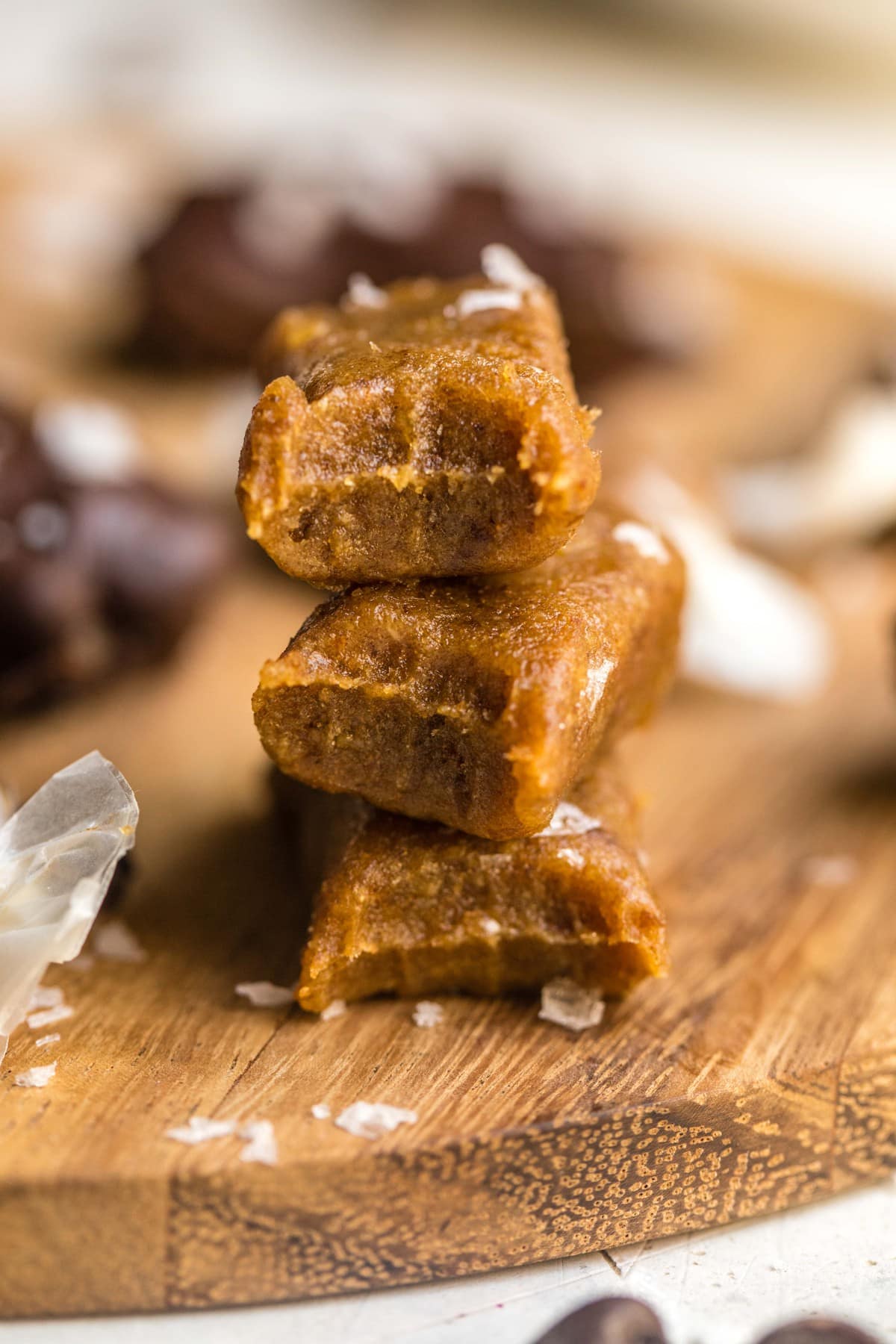 stack of salted caramel bites on wood cutting board