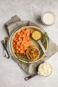 ingredients for sweet potato and rosemary quiche on light gray background
