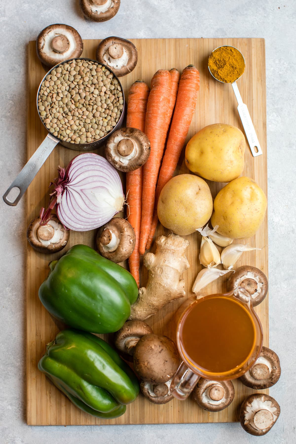 ingredients for curried lentil soup on wooden cutting board