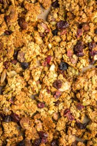 close up photo of crispy baked granola clusters on baking sheet