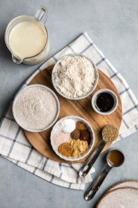 ingredients for fluffy gingerbread pancakes on wood cutting board