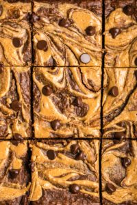 close up photo of sliced peanut butter brownies in baking tray