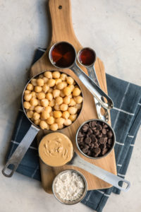 ingredients for chickpea cookie dough on wood serving platter