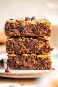 stack of peanut butter brownies on white speckled plate