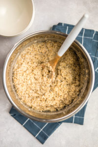 cooked steel cut oatmeal in instant pot with wooden spoon