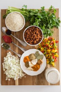 ingredients for arroz con guandules on wooden cutting board